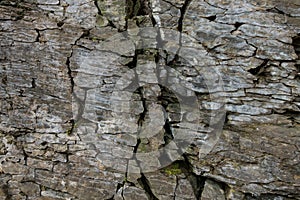 Stone wall of rock with cracks