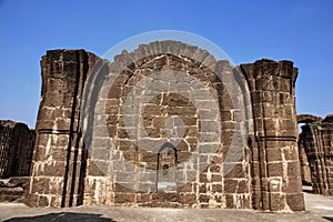 A stone wall in the ruins of the ancient Bara Kaman monument