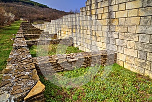 Stone wall and ruins of ancient fortress
