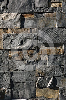 Stone wall in sunlight. Sharp shadows emphasize the textere. Different size cut out gray marble wall texture photo