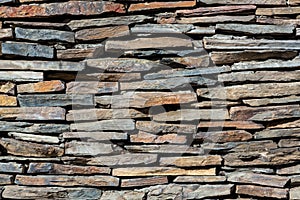 The stone wall texture background natural color.Background of stone wall texture photo.Natural stone wall texture for background.O