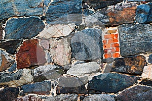 Stone wall texture background. Old rough outdoor rocks surface. Close-up natural pattern.