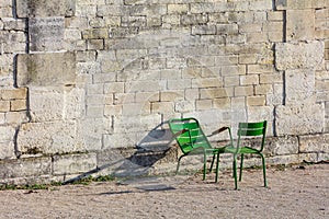 Stone wall and two green chairs in Tuileries Garden (Horizontal)
