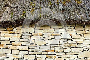 Stone wall under the thatched roof