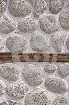 Stone wall with wooden beam closeup