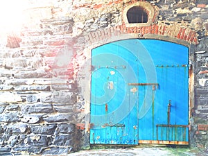 Stone wall with wooden door blue.