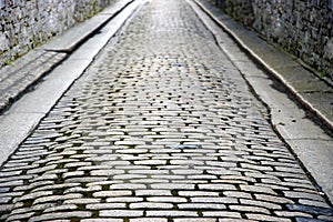 Stone walled cobbled street