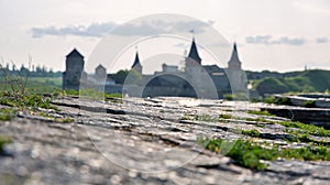 Stone walls with Kamianets-Podilskyi castle in the background, Ukraine