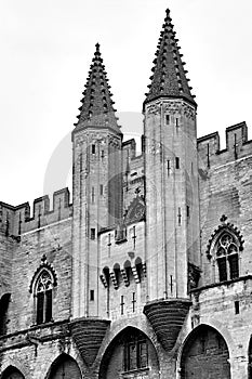 Stone walls and towers of the medieval Castle of the Popes in the city of Avignon