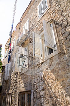 Stone walls and wooden shutters in old Budva, Montenegro