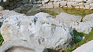 Stone water bowl at Roman wells in Rajcice