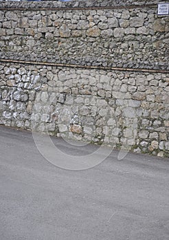 Stone Way to Mansion with Puerta de los Payaros or gate of Birds in Downtown of Comillas Resort in Spain