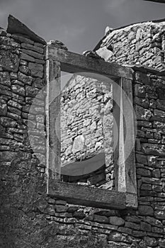 Stone window in demolished wall