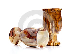 Stone wine-glasses from onyx on a white background