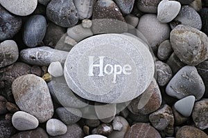 Stone with the word Hope on stone background