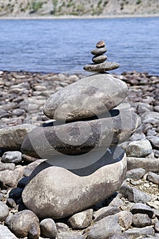 Stone zen tower on a river bank