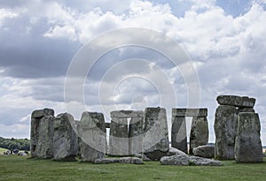 Stonehenge - cloudy skies and green meadows.