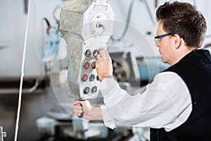 Stonemason operating stone saw