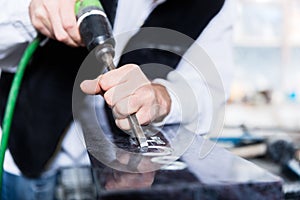 Stonemason operating stone saw