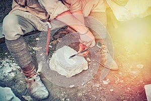 Stonemason in the quarry has a chisel stones. Mason working with a stone of white limestone