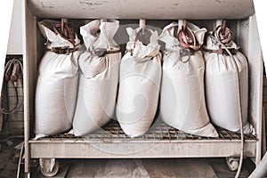 in the stonemasonry company the vacuumed dust is collected in white bags photo