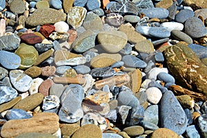 Stones background in gray, white, brown, orange and blue hues