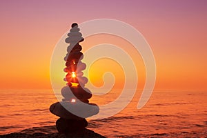 Stones balance on a background of sea sunset. Concept of harmony