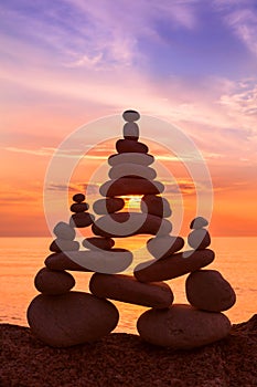 Stones balance on a background of sea sunset. Concept of harmony and balance