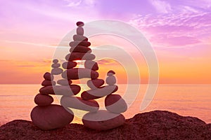 Stones balance on a background of sea sunset. Concept of harmony and balance