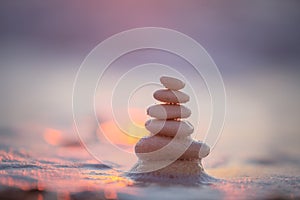 Stones balance on beach, sunrise shot. Zen meditation and relaxation