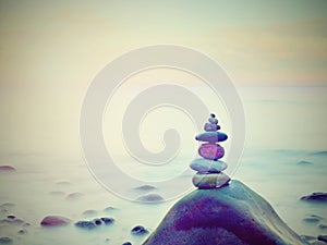 Stones balance on rounded stone at sea, concept inspiration. Beautiful landscape background