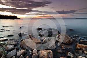 Stones on beach in Pitea in Sweden during summer sunset