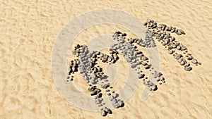 Stones on beach sand handmade symbol shape, golden sandy background, children holding hands sign