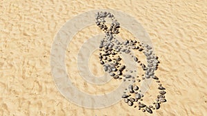 Stones on beach sand handmade symbol shape, golden sandy background, musical note sign
