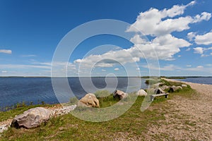 Stones and bench at the shore of the lake FilsÃ¸ in Denmark