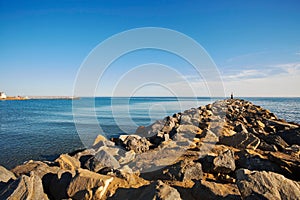 Stones breakwaters to protect coastal structures from destructive impact of storm sea waves. Cabopino beach