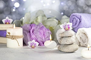 Stones, burning candles, towel, abstract lights. Spa resort therapy composition