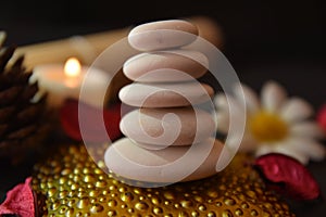 Stones Cairn and Candles for Quiet Zen Meditation flowers on black background