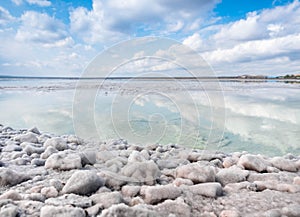 The stones are covered with a crust of salt on the shores of the salar Baskunchak. Extraction of salt