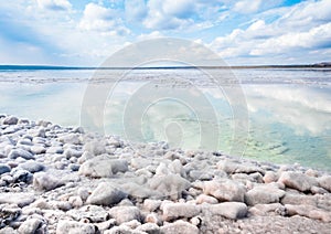 The stones are covered with a crust of salt on the shores of the salar Baskunchak. Extraction of salt