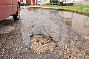 Stones filled pot hole in the road