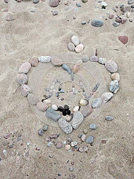 Stones heart on sand