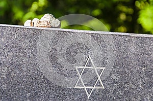 Stones on Jewish Memorial granite plate with Star of David