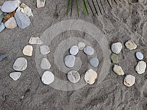 Stones on a large sand laid out the name of a resort town in Russia, translated from Russian - Loo