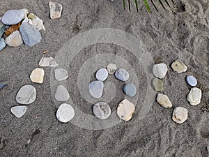 Stones on a large sand laid out the name of a resort town in Russia, translated from Russian - Loo