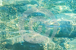 The stones lie under the clear water view