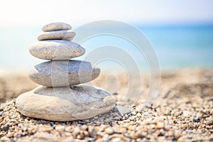 Stones are lined with pyramid on beach. Pebbles. Stones pyramid symbolizing zen, harmony