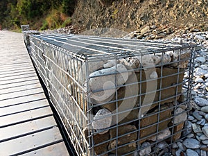 Stones in metal wire cage - Steel mesh of gabion wall