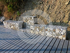 Stones in metal wire cage - Steel mesh of gabion wall