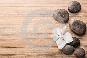 Stones and orchid flower on background, top view with space for text. Zen lifestyle